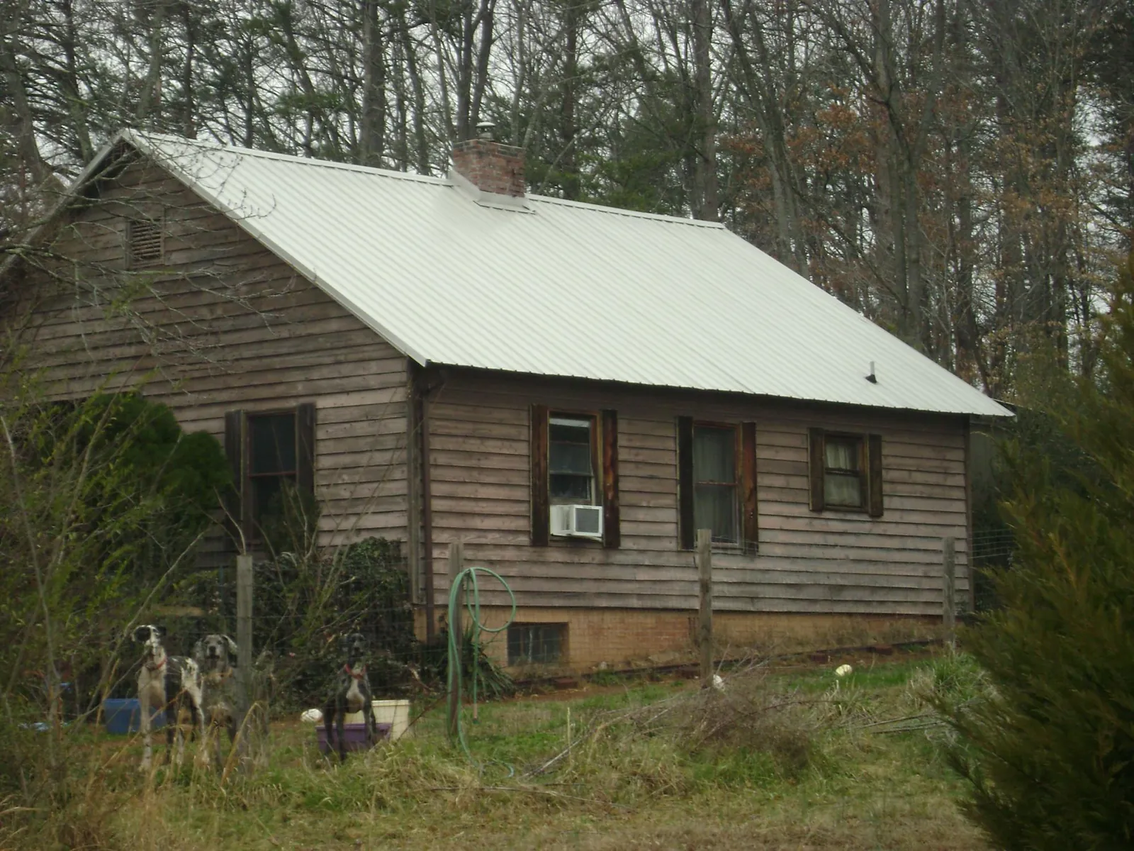 White metal roof on an old wood sided farmhouse, from a Metal Roof Installation job in Shiloh