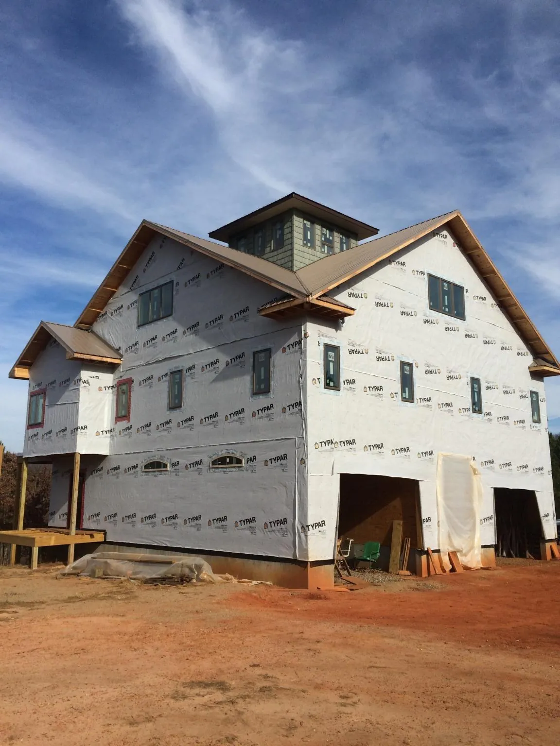 New two story house under construction with a cupola and gabled roofs in Shiloh